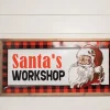 28” Wood and Metal Embossed “Santa’s Workshop” Wall Decor